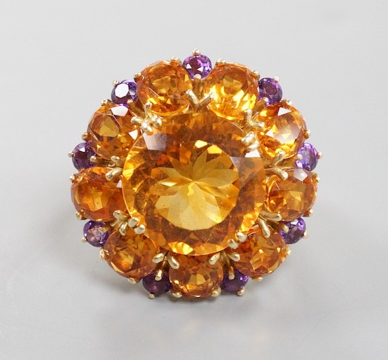 A large 14k, citrine and amethyst cluster set flower head dress ring, with diamond chip set shoulders, size H, gross weight 11.4 grams.